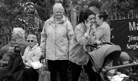 Society People waiting for a bus, woman on phone pushing a buggy