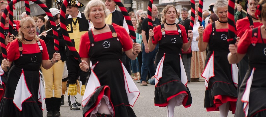 Dancing Female morris dancers in black and red costume